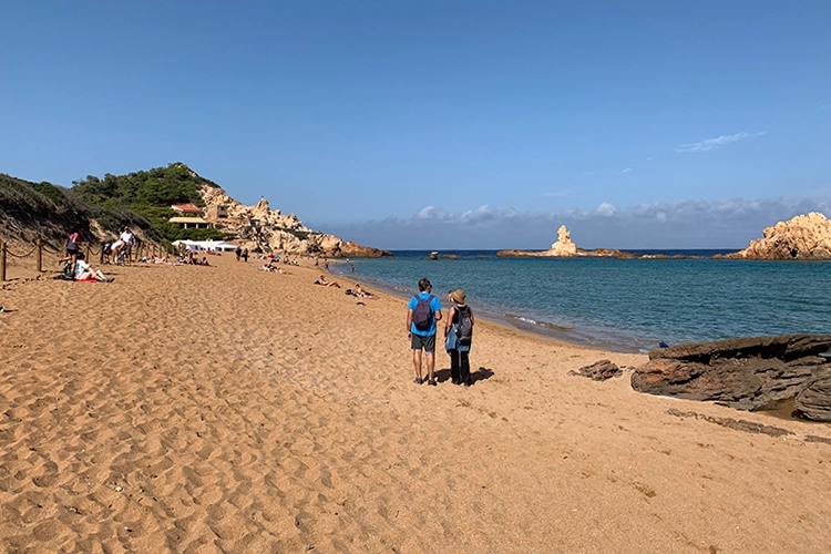 The rich golden-reddish hue of the sand at the beach